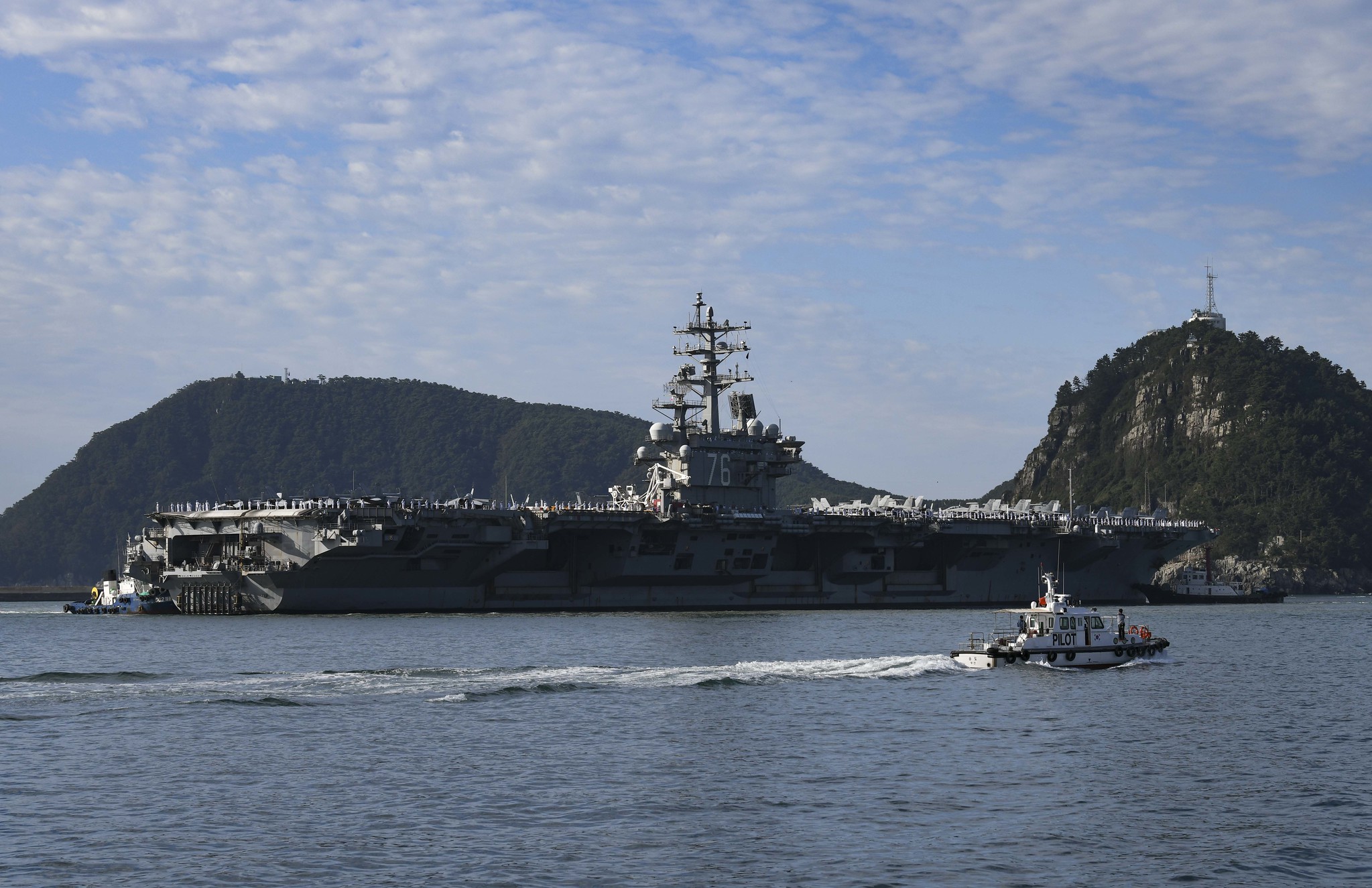 BUSAN, Republic of Korea (Sept. 23, 2022) Tugboats maneuver the Navy’s only forward-deployed aircraft carrier USS Ronald Reagan (CVN 76) to moor in Busan, Republic of Korea. (Source: U.S. Navy photo by Mass Communication Specialist 2nd Class Leon Wong via Flicker)
