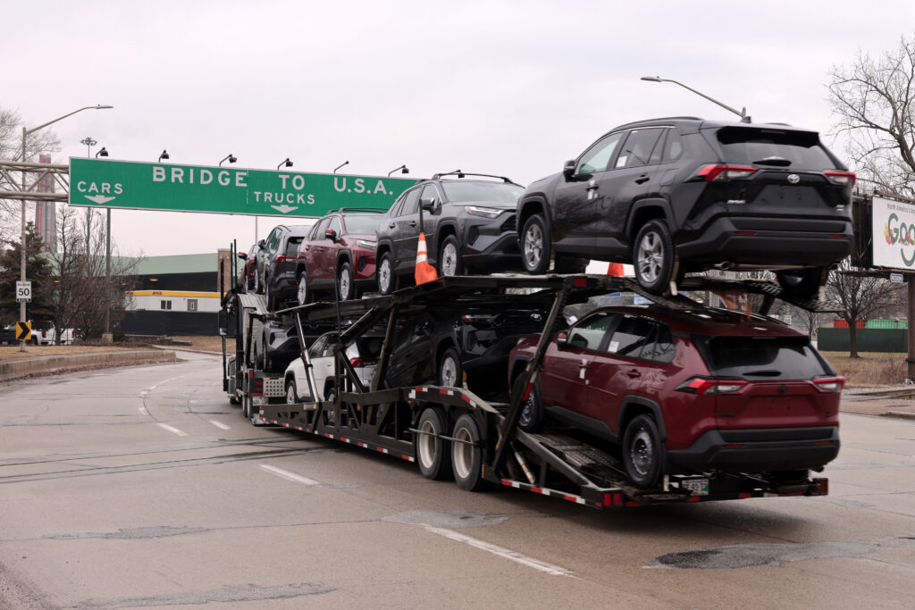 A car hauler carries Toyota RAV4 vehicles as it enters to cross the Ambassador Bridge in Windsor, Ontario to go to Detroit, Michigan on February 3, 2025. US President Donald Trump paused tariffs on Mexico for one month after last-minute talks Monday -- but there was no breakthrough yet in negotiations with Canada on an issue that has sparked fears of a global trade war. (Photo by JEFF KOWALSKY / AFP) (Photo by JEFF KOWALSKY/AFP via Getty Images)