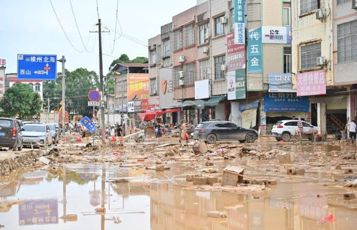 GUIGANG, CHINA - JULY 09: Residents clear silt and debris after floodwater recedes on July 9, 2026 in Guigang, Guangxi Zhuang Autonomous Region of China. Recent extreme rainstorms triggered by Typhoon Maysak, the 10th typhoon of the year, have caused severe flooding in parts of Guangxi in the Pearl River basin. Guangxi is continuing its search and rescue operations for missing persons, enhancing resettlement services for affected residents and advancing post-disaster reconstruction. (Photo by Yu Jing/China News Service/VCG via Getty Images)